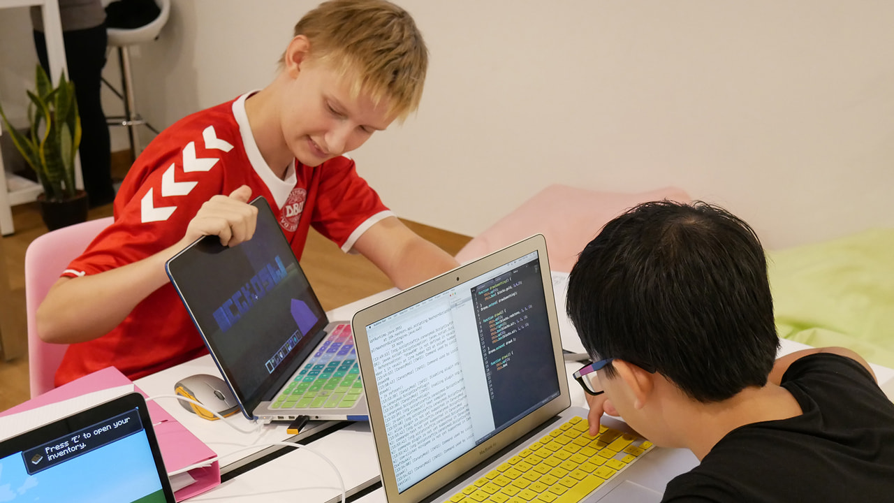 Two teenagers working on their code at LCCL