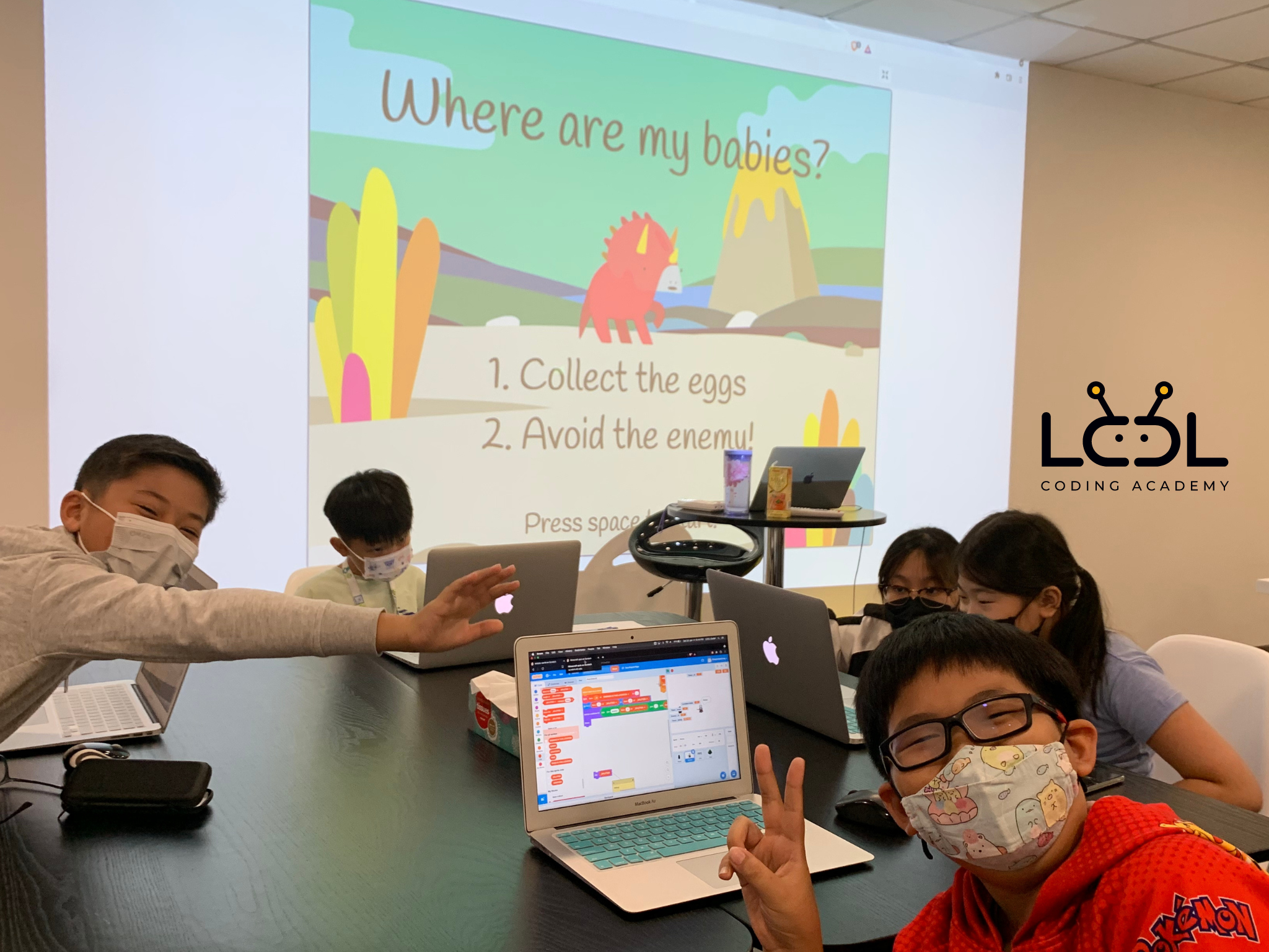 LCCL students coding a Scratch game with projected screen