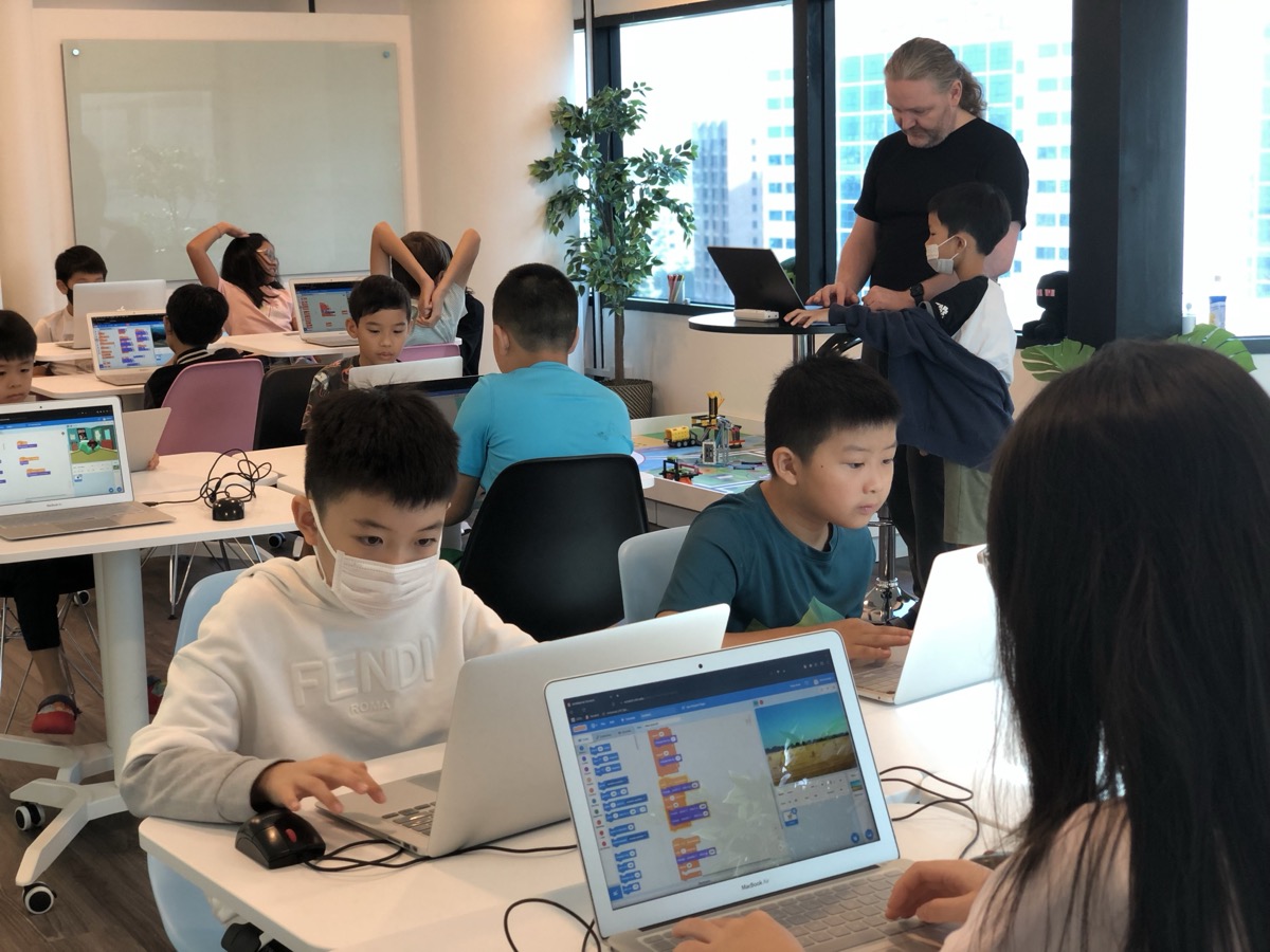 Students coding with teacher guidance at LCCL