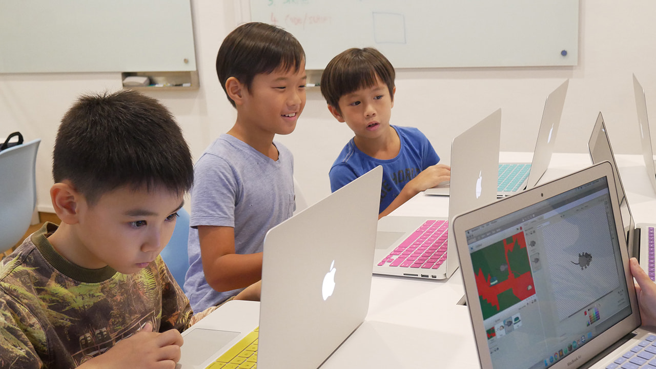 Kids building games on laptops at LCCL